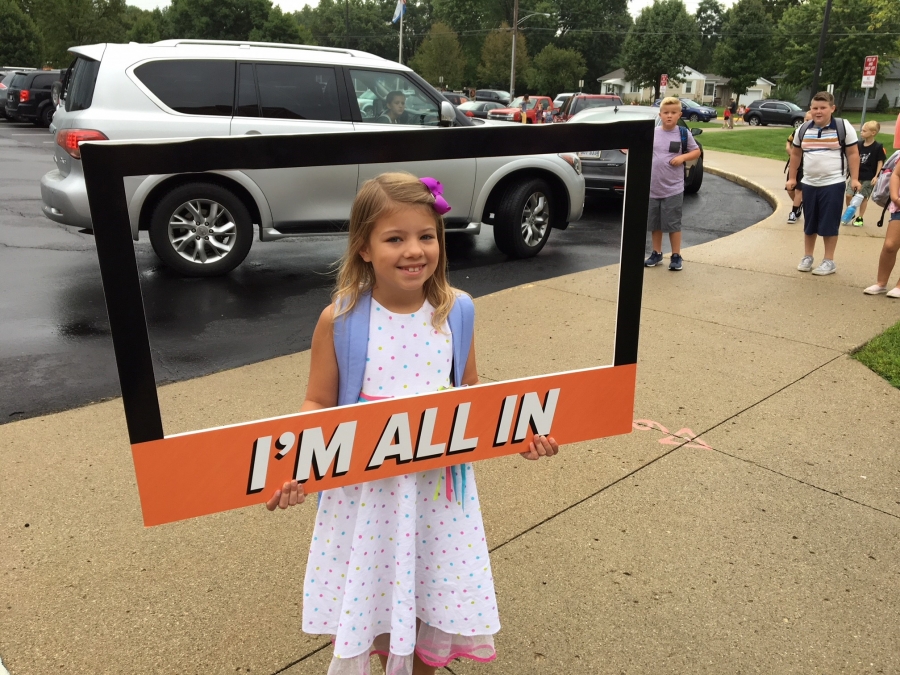 people holding a frame sign